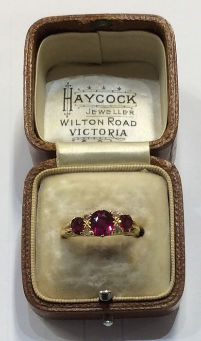 An 18 carat ruby and diamond seven stone ring in c