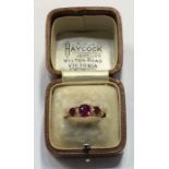 An 18 carat ruby and diamond seven stone ring in c