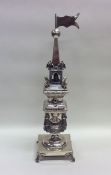 A tall silver spice tower attractively decorated w