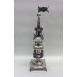 A tall silver spice tower attractively decorated w