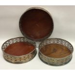 A trio of Georgian cast silver coasters decorated