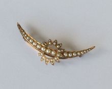 A 15 carat gold crescent brooch with sunburst. App