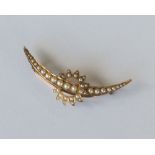 A 15 carat gold crescent brooch with sunburst. App