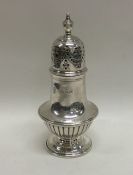 A small half fluted baluster shaped silver pepper.