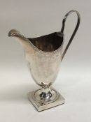 A Georgian silver cream jug with bead work decorat