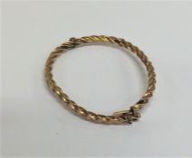 A 9 carat twist bangle with concealed clasp. Appro