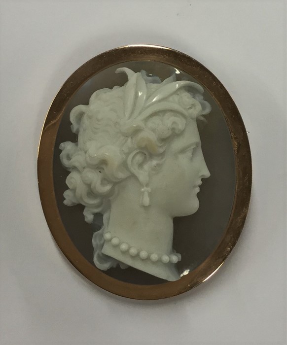 An oval hard stone cameo of a lady's head in gold