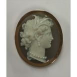 An oval hard stone cameo of a lady's head in gold