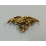 An attractive French cast gold brooch in the form