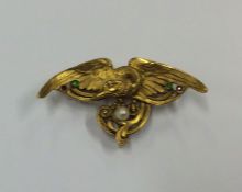 An attractive French cast gold brooch in the form