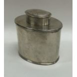 An oval silver tea caddy with lift-off cover. Appr