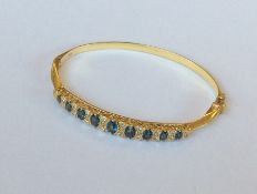 An 18 carat diamond mounted hinged bangle with con