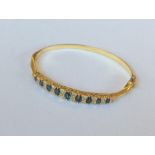 An 18 carat diamond mounted hinged bangle with con