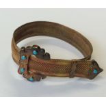 A heavy gold and turquoise bracelet of buckle desi