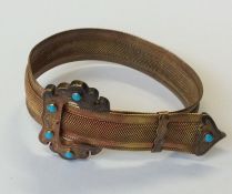 A heavy gold and turquoise bracelet of buckle desi