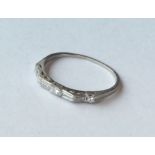 An unusual platinum and diamond half eternity ring