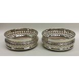 A pair of attractive Edwardian silver wine coaster