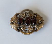 A cabochon garnet brooch. Approx. 11 grams. Est. £