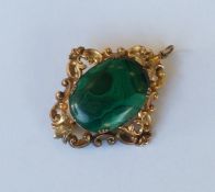 A gold malachite brooch / pendant decorated with l