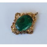 A gold malachite brooch / pendant decorated with l