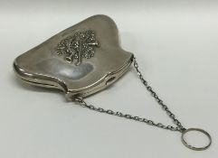 A silver purse decorated with musical instruments