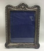 A massive easel back silver picture frame with scr