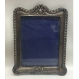 A massive easel back silver picture frame with scr