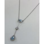 A good quality aquamarine and diamond three stone