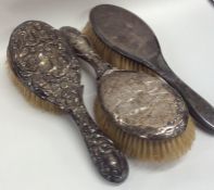 Three silver mounted hairbrushes. Est. £10 - £15.