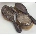 Three silver mounted hairbrushes. Est. £10 - £15.