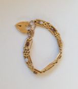 A garnet and opal gate bracelet with heart shaped