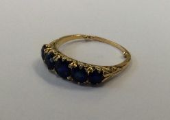 A sapphire five stone half hoop ring in 18 carat m