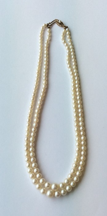 A double string of cultured pearls with gold clasp