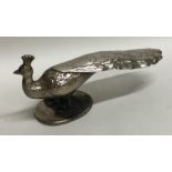 A novelty silver model of a peacock on oval base.