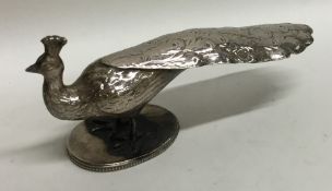 A novelty silver model of a peacock on oval base.