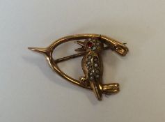A gold brooch mounted with a Kookaburra. Approx. 2