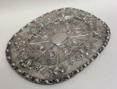 An 18th Century oval embossed silver letter tray d