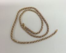 A 9 carat two colour gold twist necklace with ring