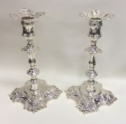 A good pair of Georgian cast silver candlesticks w