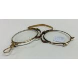 A small pair of gold quizzing glasses in leather p