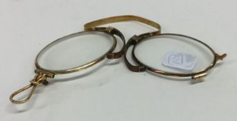 A small pair of gold quizzing glasses in leather p