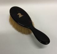 A tortoiseshell mounted and gold inlaid brush. Est