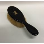 A tortoiseshell mounted and gold inlaid brush. Est