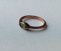 A marquise shaped peridot single stone ring in 9 c