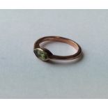 A marquise shaped peridot single stone ring in 9 c