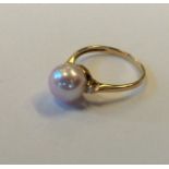 A pearl and diamond three stone ring in 9 carat mo