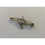 An 18 carat white gold brooch decorated with a flo