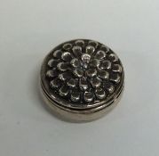 A small modern silver box decorated with flowers t