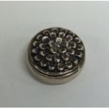 A small modern silver box decorated with flowers t