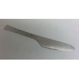 A heavy modernistic silver butter knife with textu